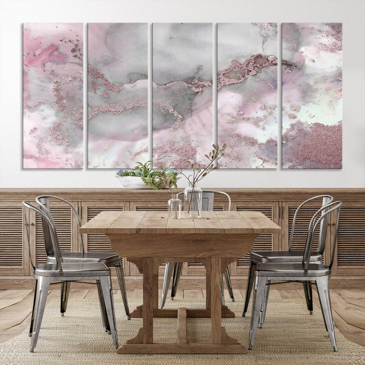 The Rose Marble Abstract Wall Art Canvas Print is a stunning triptych that showcases pink and gray tones, elegantly presented on a dark wall.