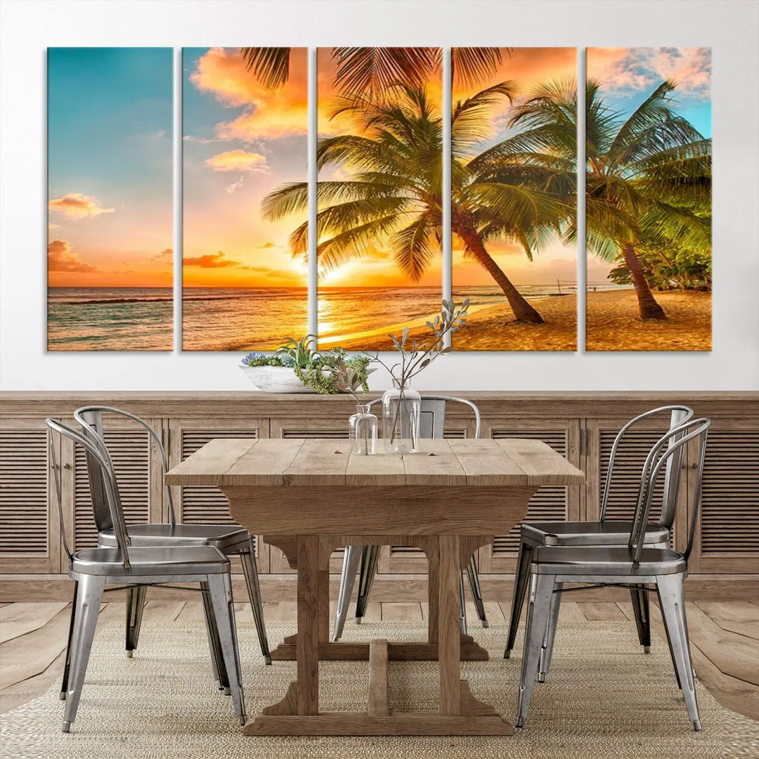 The Tropical Sunset Wall Art Print features a vibrant beach scene with palm trees and an ocean view highlighted by a golden sunset.