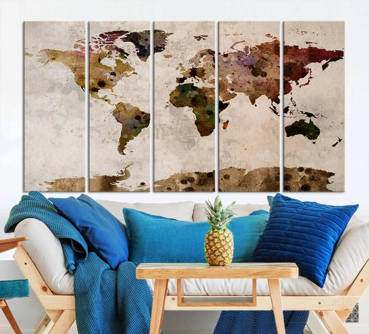 A Watercolor World Map Canvas Print, wrapped in an elegant gallery style, hangs on the wall.