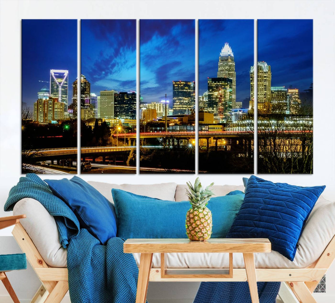 A modern living room highlighted by the "Charlotte City Lights Cloudy Blue Night Skyline Cityscape View" wall art canvas print, crafted on museum-quality canvas with UV-protective coating.