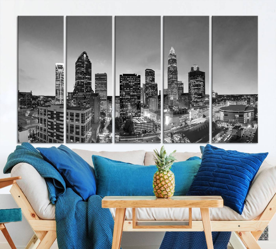 The "Charlotte City Cloudy Skyline Black and White Wall Art Cityscape Canvas Print" hangs on a dark wall, showcasing its UV-protective properties for enduring beauty.