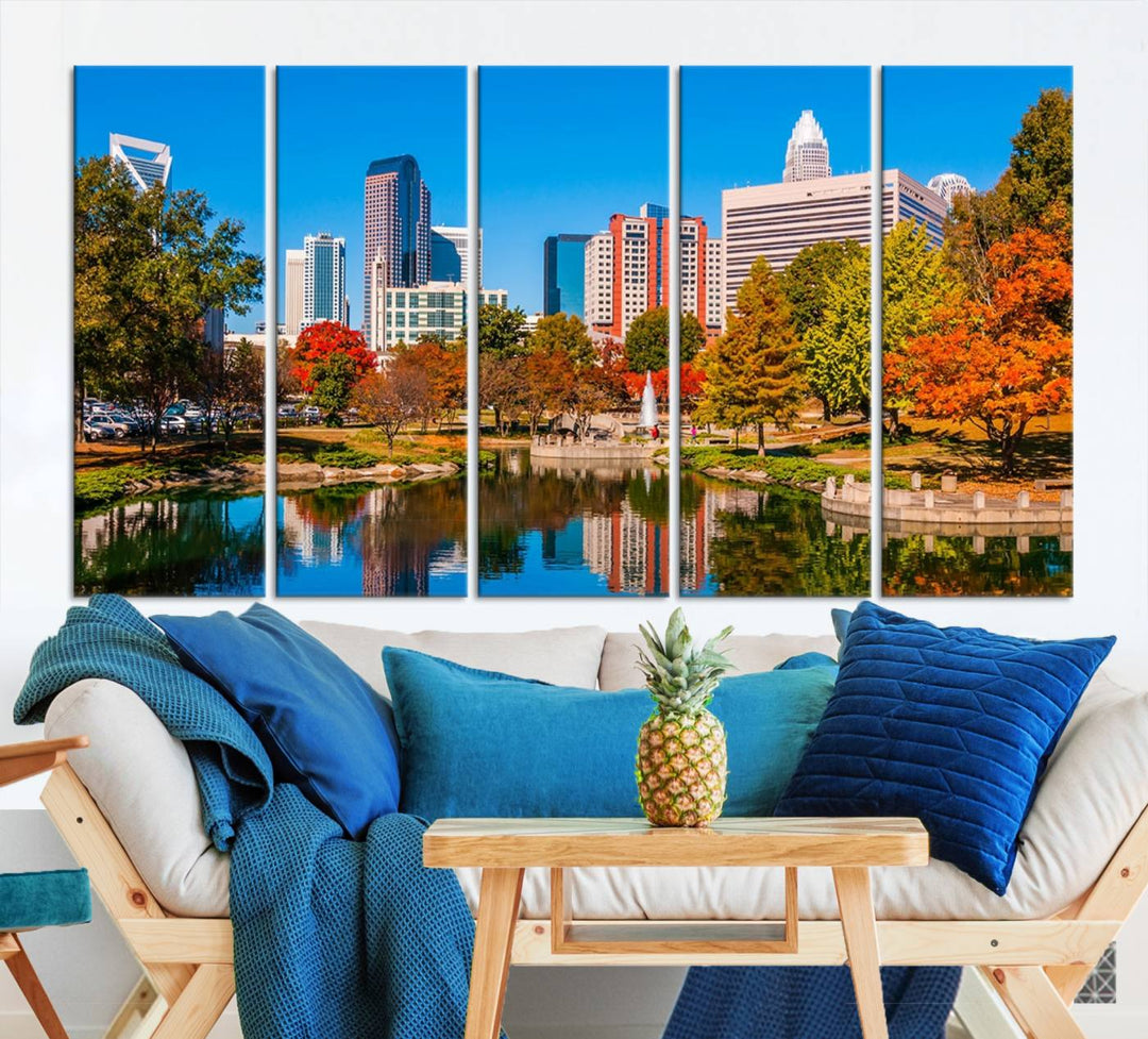 The Charlotte City Park at Fall Skyline Cityscape View wall art canvas print features a city panorama with a park and lake accented by autumn trees. It is mounted on museum-quality canvas with UV-protective coating and decorates the space.