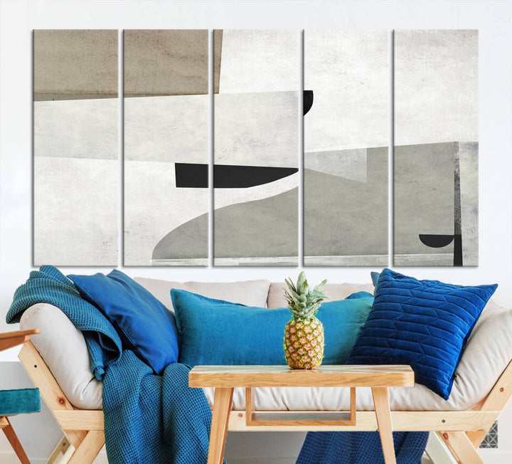 The Brown Gray Figures Abstract Wall Art Canvas Print is displayed as a triptych on a dark wall. The piece is gallery wrapped, offering a seamless finish and enhanced durability due to its UV-protective coating.