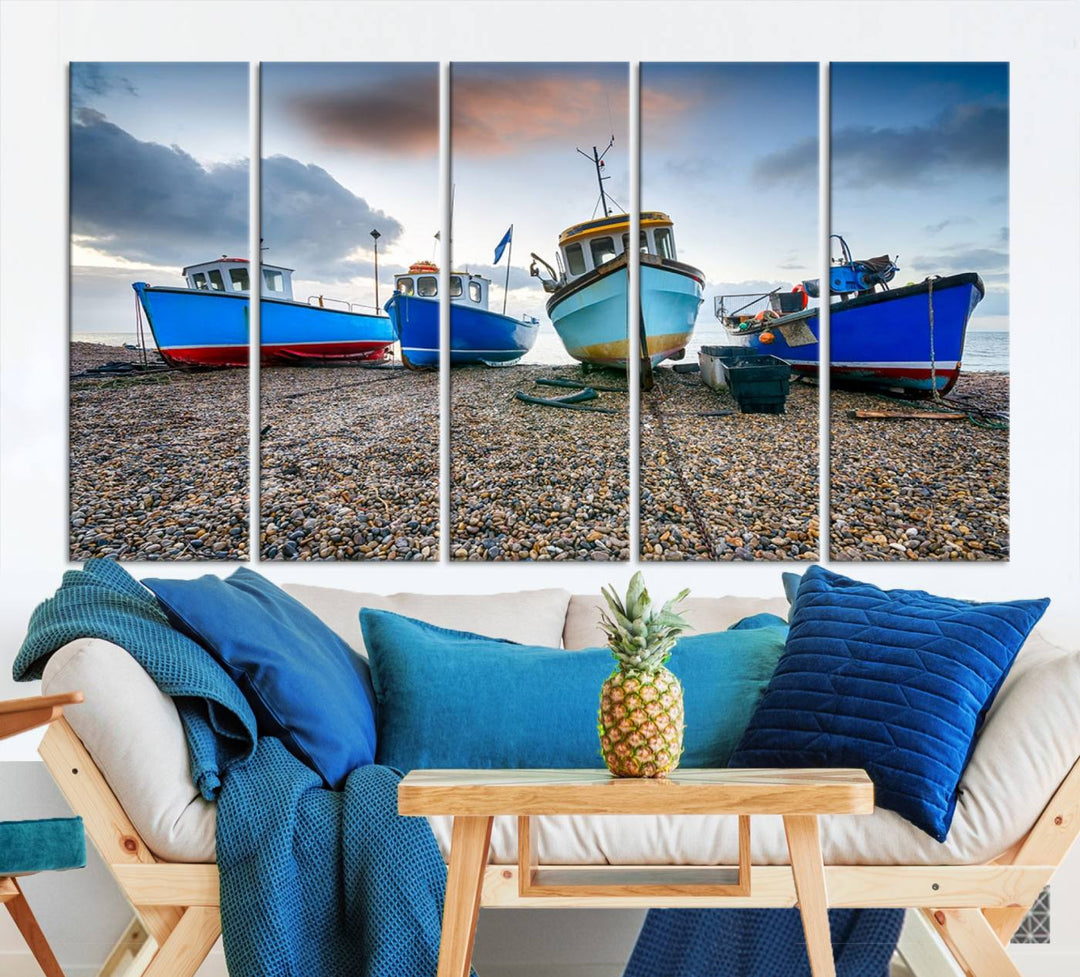 The "Big Boats On The Beach Wall Art Canvas Print" is a stunning piece featuring three museum-quality panels depicting fishing boats on a pebbled shore. Ready to hang and featuring UV-protective coating, it serves as an elegant addition to your home décor.