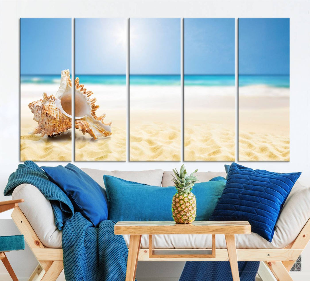 The Sea Shell on The Beach Sun Sand Wall Art Canvas Print is a triptych that beautifully captures a beach scene with a large seashell on the sand.