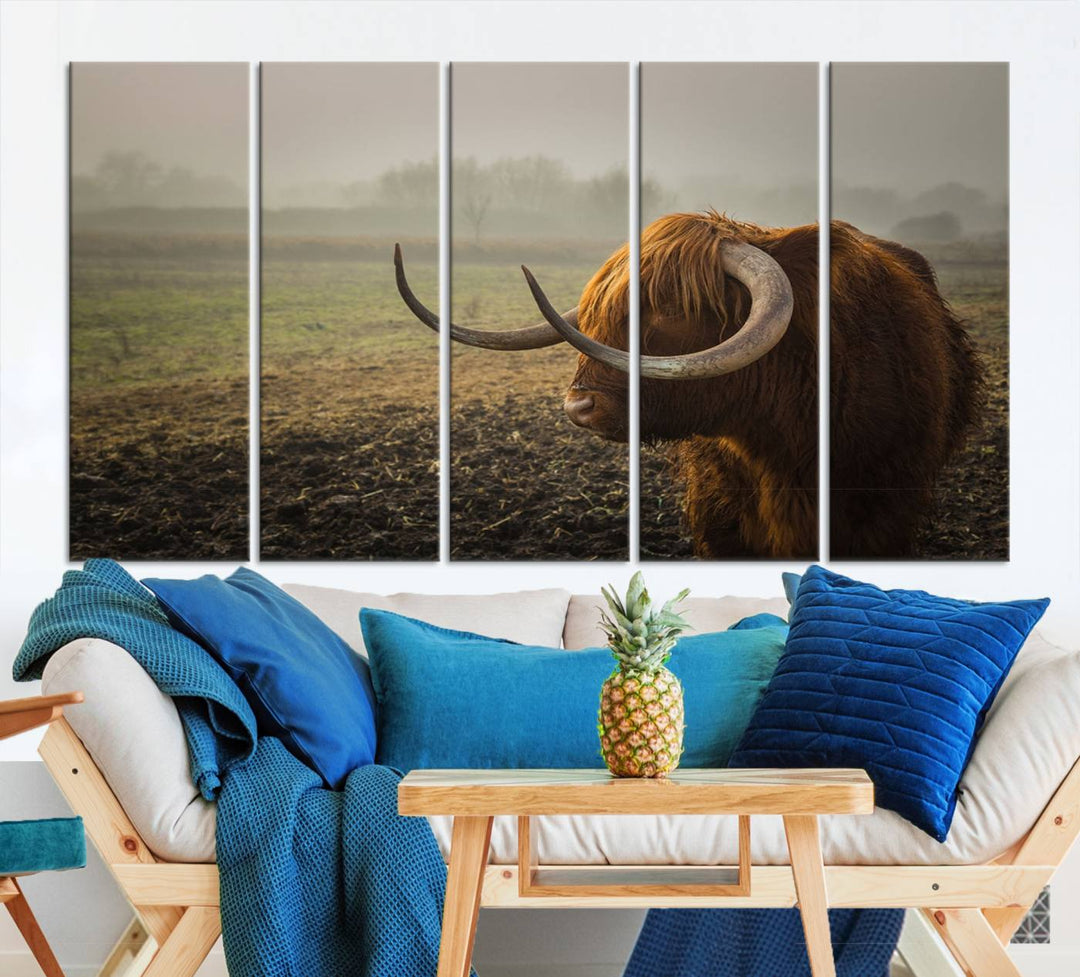 The "Big Cow Horn Wall Art Canvas Print" is a hand-assembled framed canvas depicting a Highland cow in a misty field. It is crafted with a UV-protective coating to ensure lasting vibrancy.