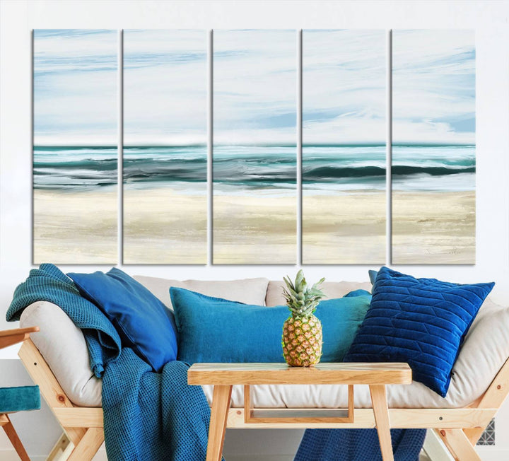 The room features the Ocean Abstract Wall Art Canvas Print, a triptych beach painting on museum-quality canvas with a gallery-wrapped finish and UV-protective coating.