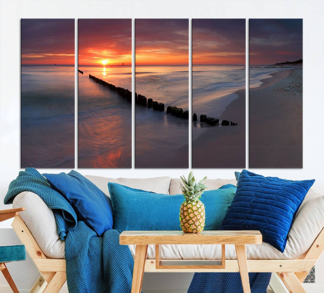 In a modern living room, the Sunset Beach Wall Art Canvas Print is displayed above. This triptych, printed on museum-quality canvas with a UV-protective coating, ensures lasting brilliance. It's ready to hang and brings an elegant touch to your space.