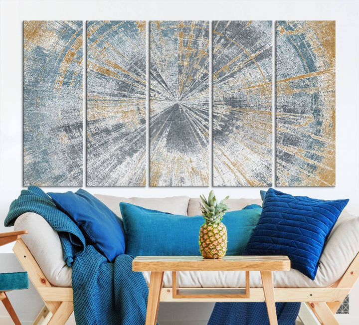 The Radiant Abstract Wood Rings Canvas Art, a modern triptych wall decor, enhances the contemporary style of the living room with its blue, white, and gold hues.