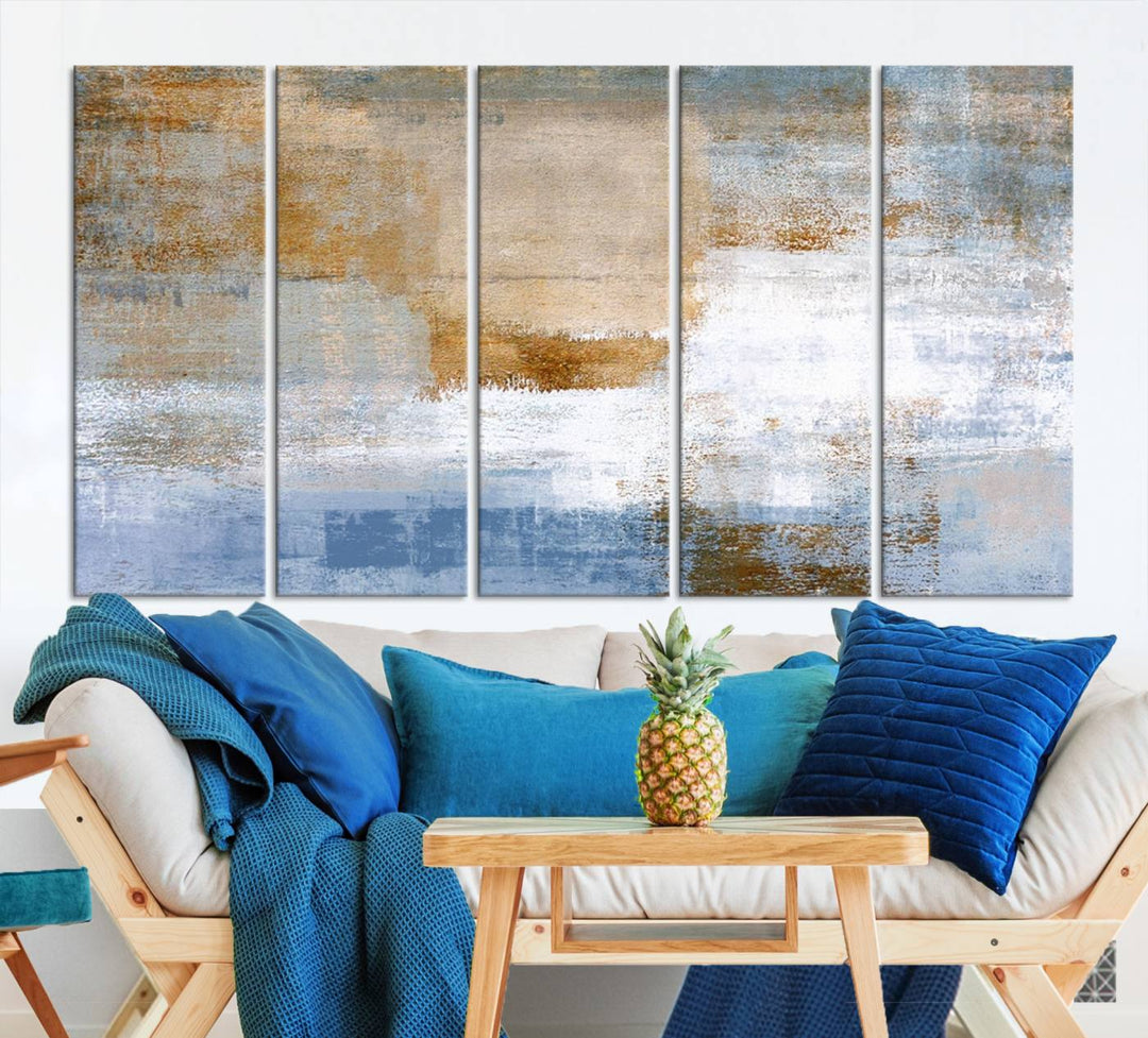 The Blue Multi Panel Abstract Wall Art Canvas Print, featuring an elegant blend of blue, beige, and brown tones, hangs gracefully on the wall, adding a contemporary touch to the space.