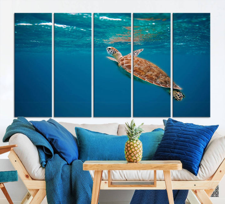 The living room features the "Baby Turtle in Ocean" wall art canvas print. This gallery-quality piece, depicting a sea turtle swimming underwater, adds an elegant touch to the space.