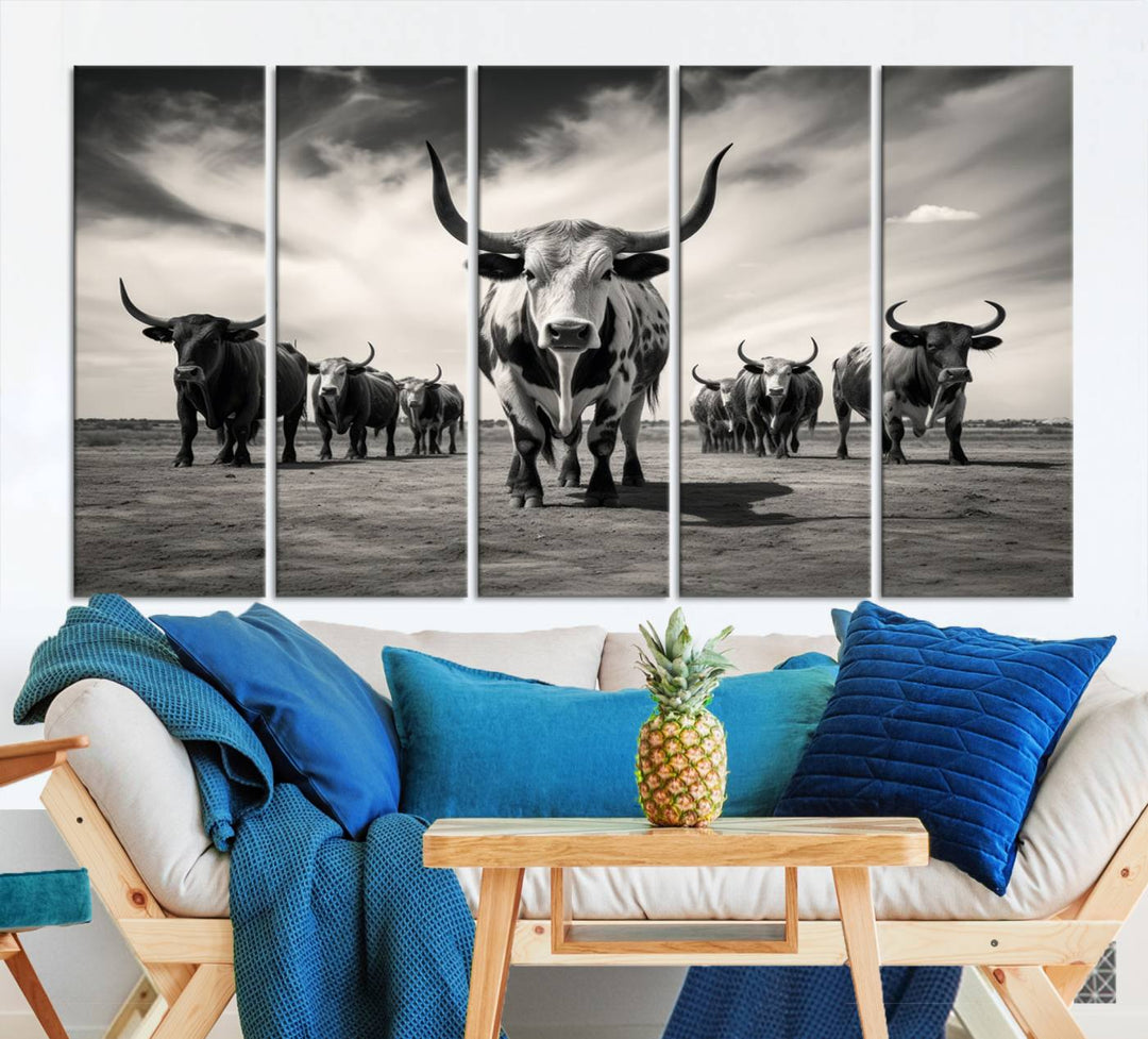 The Black and White Longhorn Cattle Wall Art, featuring a three-panel display of cowboy Western longhorns walking toward the viewer, enhances your space with its striking presence, adding a touch of Western decor.