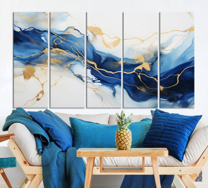 The Blue Abstract Wall Art is displayed as a triptych on museum-quality canvas, showcasing a blue and gold abstract design. The artwork includes a UV-protective coating to maintain its vibrancy and comes with the benefit of free shipping.