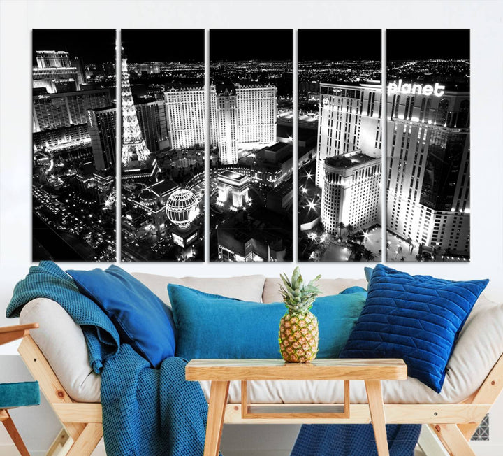 The Las Vegas Wall Art Canvas Print is a black and white triptych that showcases a city skyline at night. Crafted on museum-quality canvas with a UV-protective coating, it serves as an elegant and ready-to-hang focal point in the room.