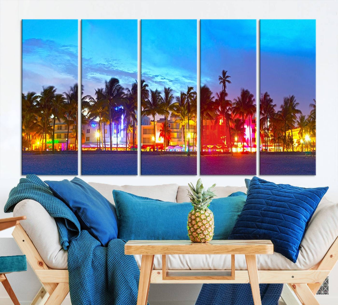 The living room features a three-panel Miami City Wall Art Canvas Print, showcasing a colorful, illuminated beach scene with palm trees on museum-quality canvas.