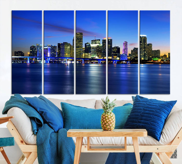 The modern living room showcases a striking Miami Blue Night Wall Art canvas print on the wall. The artwork is gallery wrapped on museum-quality canvas, ensuring durability and elegance.