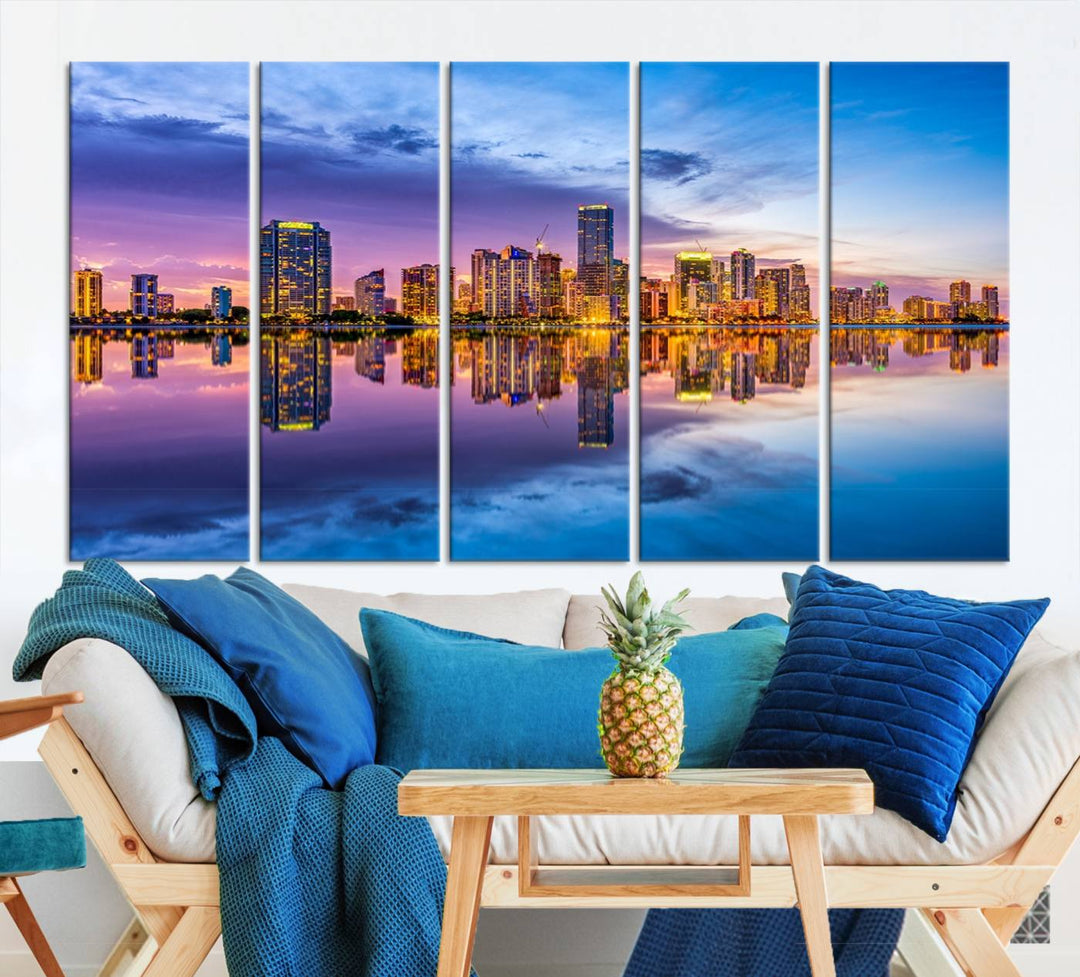 The Miami City Wall Art Canvas Print, featuring a three-panel depiction of a city skyline at sunset reflected in water, beautifully enhances the wall. Made with museum-quality canvas and a UV-protective coating, it comes ready to hang.