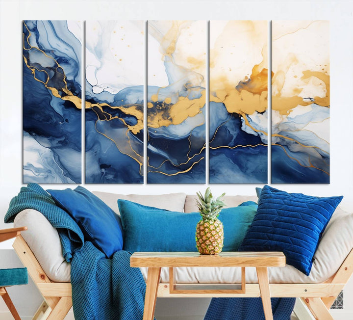 A contemporary living room featuring the "Navy Blue Gold Abstract Wall Art Canvas Print" on the wall, displayed on a gallery-wrapped, museum-quality canvas.