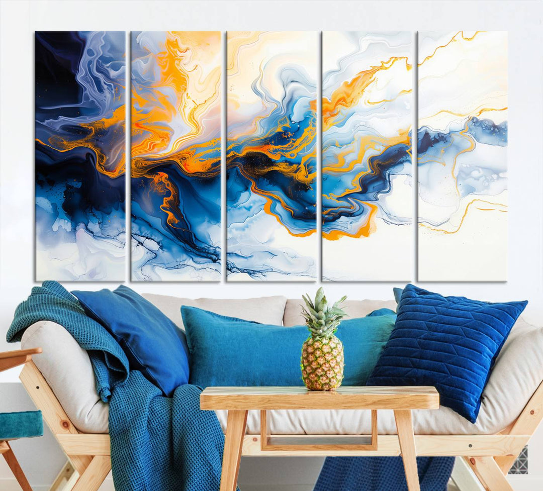 A stunning Fluid Alcohol Ink Wall Art with Gold Wall Art Canvas Print, featuring vibrant blue, orange, and white swirls, adorns the wall. This gallery-quality finish adds an exquisite touch to any living space.