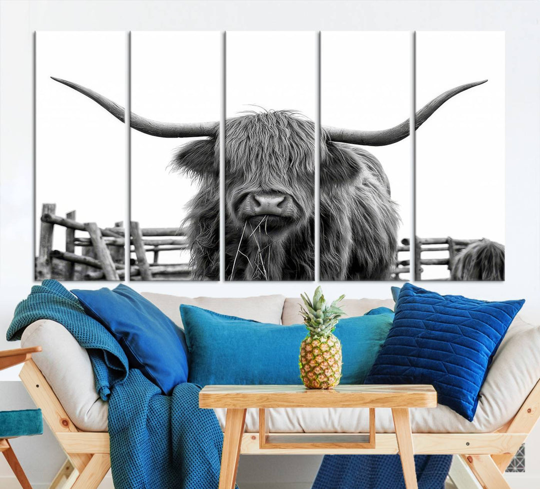 The Longhorn Canvas Print, featuring a black-and-white triptych of a Bighorn cow with shaggy fur and impressive long horns, is elegantly showcased. This wall art piece boasts a gallery-quality finish on premium canvas, bringing sophistication to any room.