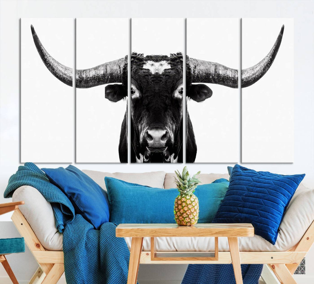 The living room is adorned with the Texas Cow Longhorn Wall Art Canvas Print in Black and White—framed and ready to hang.