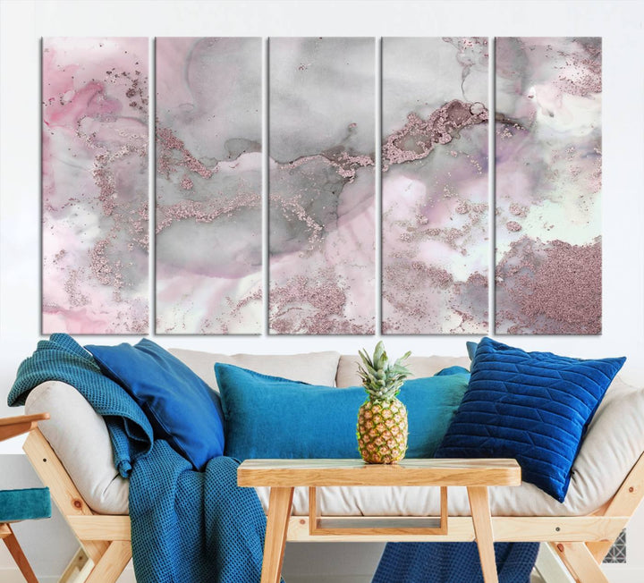 The Rose Marble Abstract Wall Art Canvas Print is a stunning triptych that showcases pink and gray tones, elegantly presented on a dark wall.