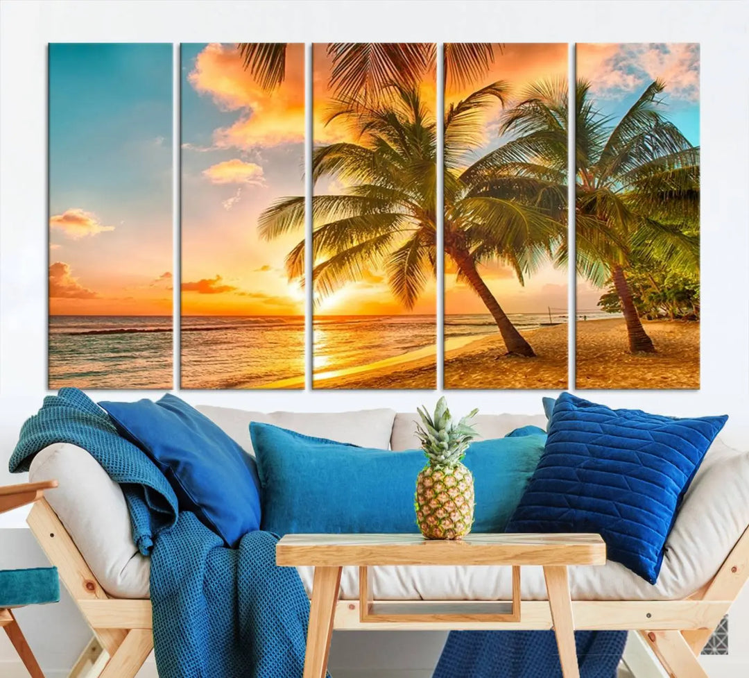 The Tropical Sunset Wall Art Print features a vibrant beach scene with palm trees and an ocean view highlighted by a golden sunset.