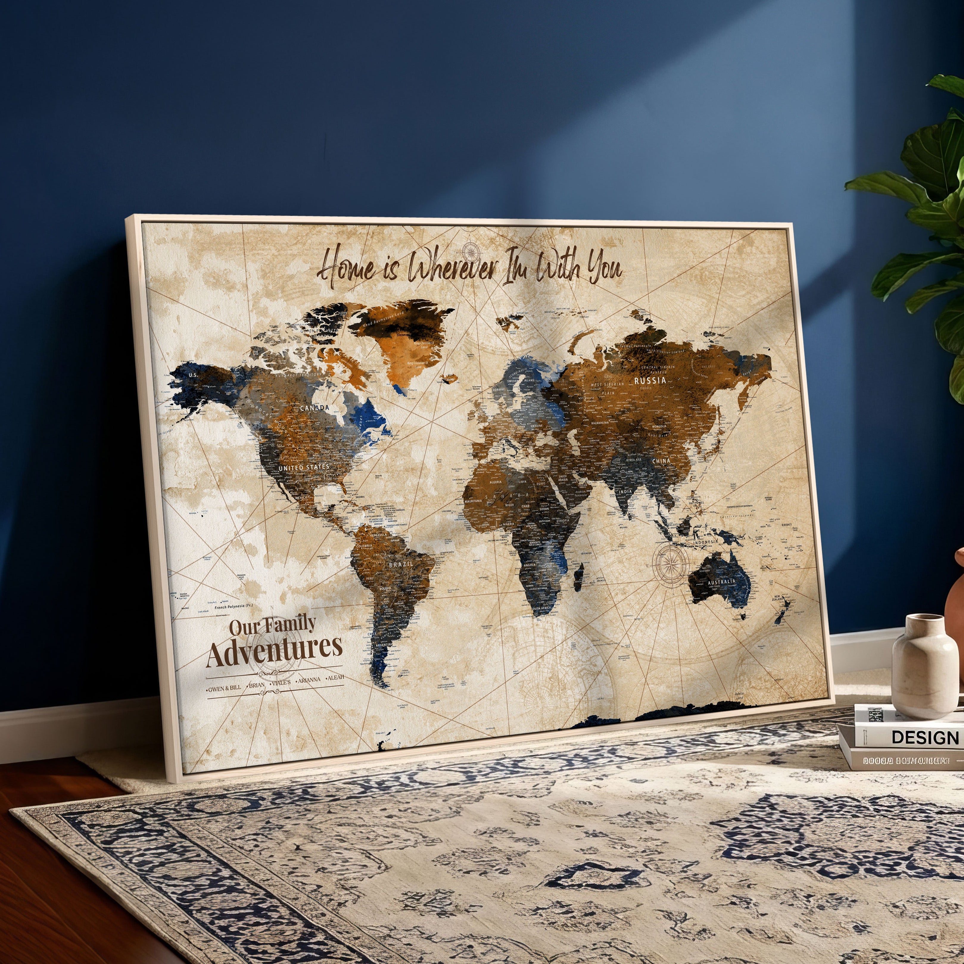 World map with text in a frame on a blue wall with a plant and decorative items.