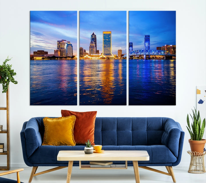 A cozy living room features the Jacksonville Wall Art Canvas Print, a large triptych crafted on museum-quality canvas that beautifully depicts the Jacksonville city skyline at sunset.