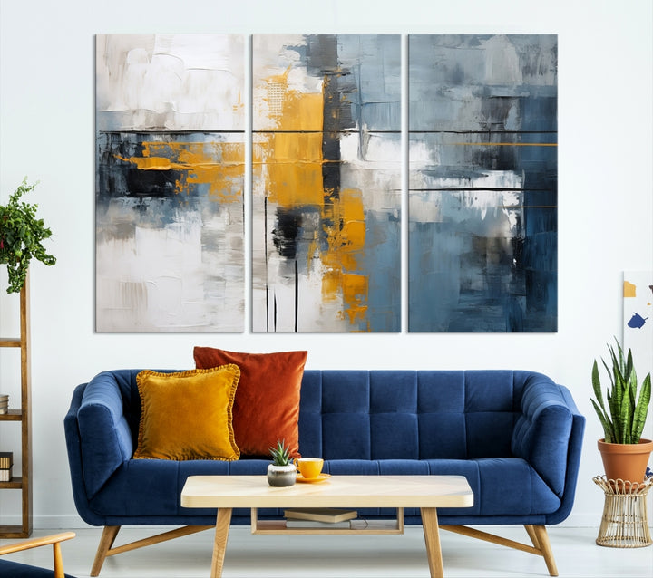 The Orange Abstract Wall Art Print features a series of white, blue, black, and yellow blocks arranged in a triptych format on museum-quality canvases. Proudly made in the USA and offered with free shipping.