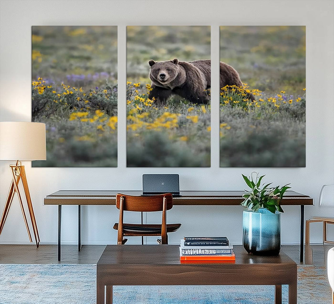 The "Grizzly 399 in Wild Flowers Wall Art Canvas Print" features a grizzly bear strolling through a field of yellow and purple flowers, beautifully showcased as a triptych. This handcrafted piece, proudly made in the USA, adds charm and sophistication to your space.