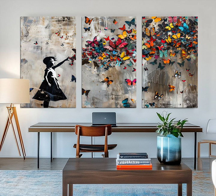 The Banksy Butterfly Girl 3-piece canvas art showcases a silhouette of a girl surrounded by colorful butterflies, perfect for modern living room decor.