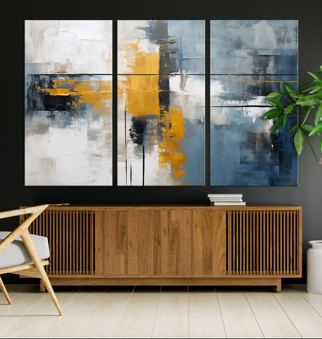 The Orange Abstract Wall Art Print features a series of white, blue, black, and yellow blocks arranged in a triptych format on museum-quality canvases. Proudly made in the USA and offered with free shipping.