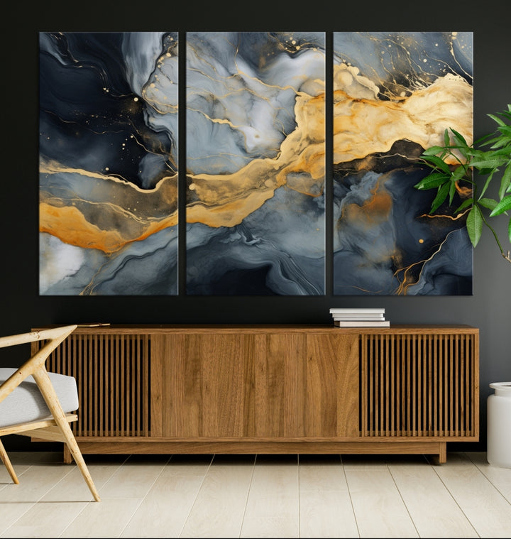 The living room features the Golden Gray Abstract Wall Art Print Contemporary Art Canvas Design, a triptych showcasing gold, black, and gray swirls. Crafted on museum-quality canvas and ready to hang, this piece is designed for elegance and durability.