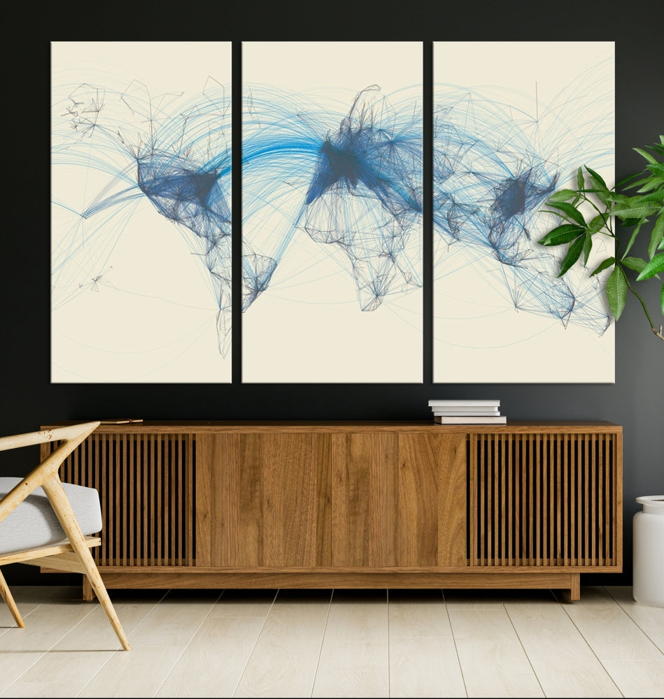 The Flight Routes Map art, featuring an abstract world map with blue connections representing global networks, is a three-panel canvas wall art piece.