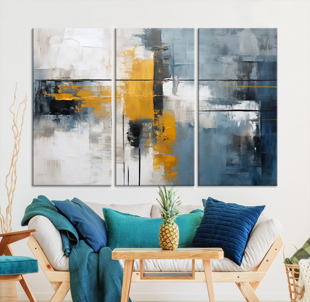 The Orange Abstract Wall Art Print features a series of white, blue, black, and yellow blocks arranged in a triptych format on museum-quality canvases. Proudly made in the USA and offered with free shipping.