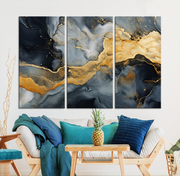 The living room features the Golden Gray Abstract Wall Art Print Contemporary Art Canvas Design, a triptych showcasing gold, black, and gray swirls. Crafted on museum-quality canvas and ready to hang, this piece is designed for elegance and durability.