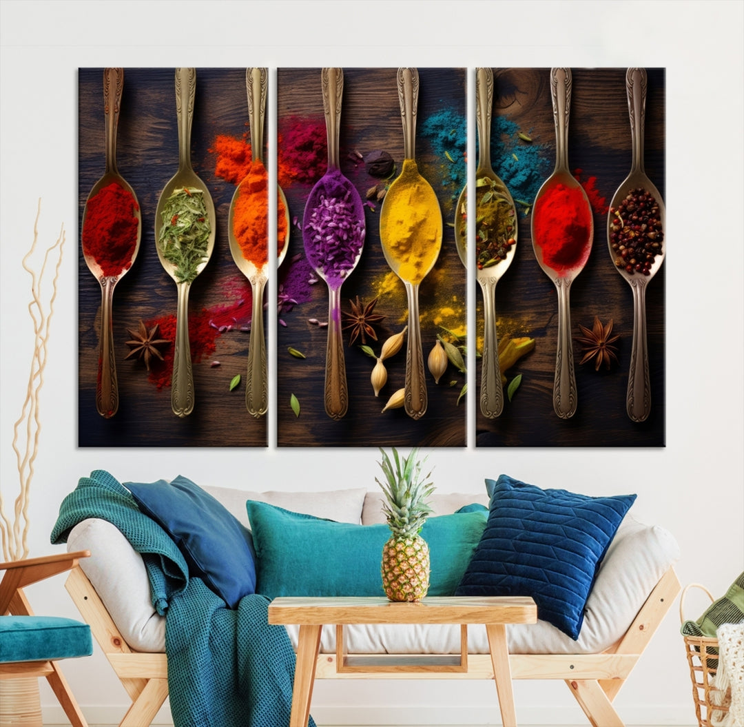 The Sponge Kitchen Wall Art Canvas Print showcases decorative artwork featuring spoons filled with colorful spices against a wooden background. Printed on museum-quality canvas, this ready-to-hang piece effortlessly adds charm and vibrancy to any space.