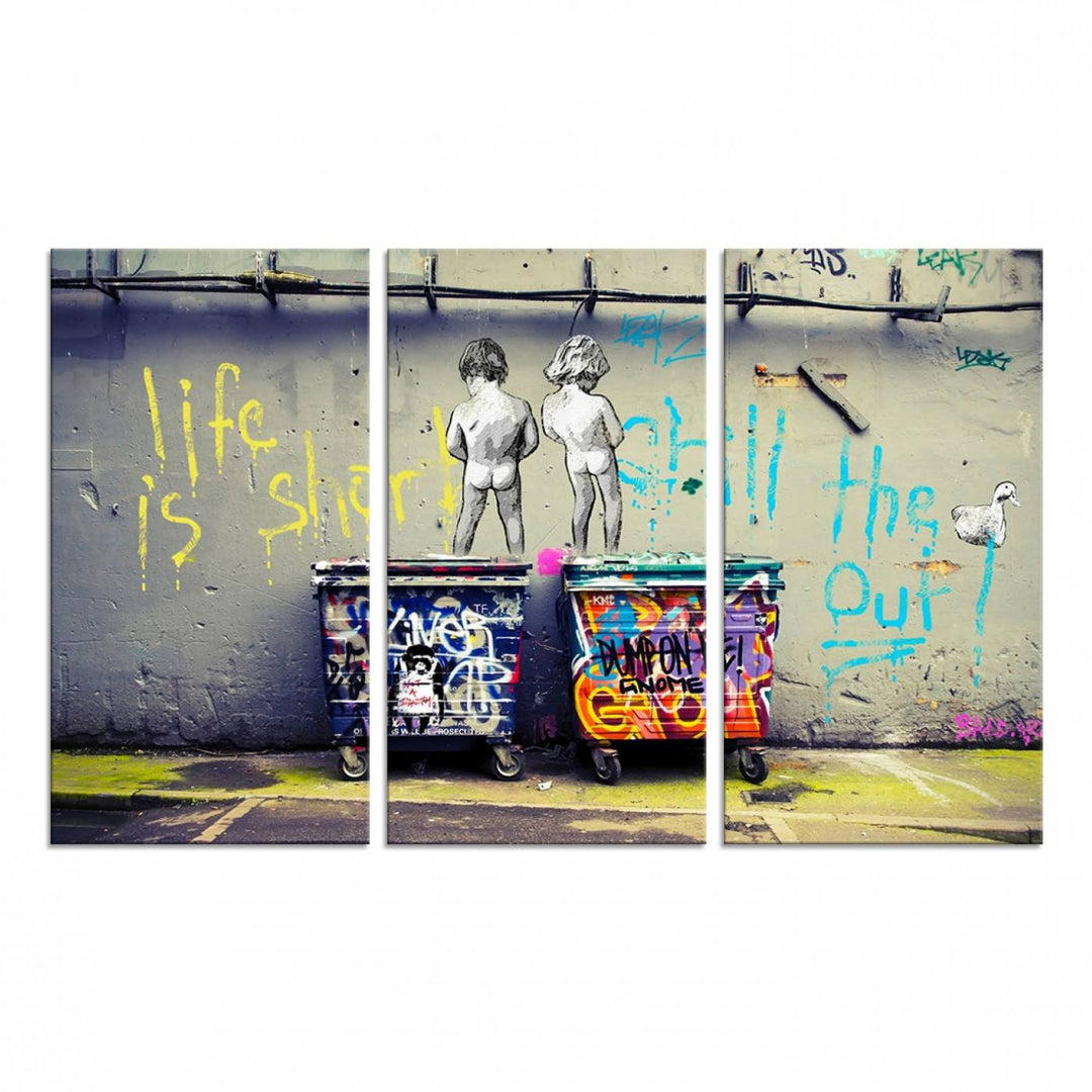 Banksys Life is Short graffiti, featuring kids and text, decorates the wall as a striking piece of framed canvas art.