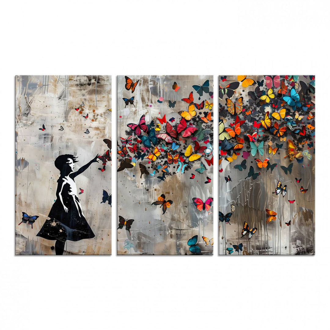 The Banksy Butterfly Girl 3-Piece Modern Graffiti Canvas Wall Art features a silhouette of a girl reaching for butterflies.