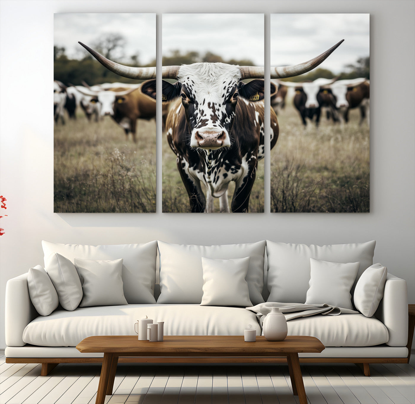 Canvas of a speckled Texas longhorn standing boldly in a field with a herd behind, perfect for rustic western or farmhouse wall decor.