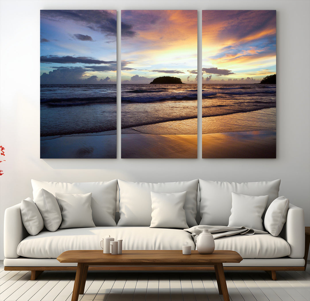A tropical beach at sunset with waves gently washing ashore, reflecting golden and purple hues in the sky, creating a tranquil coastal scene.