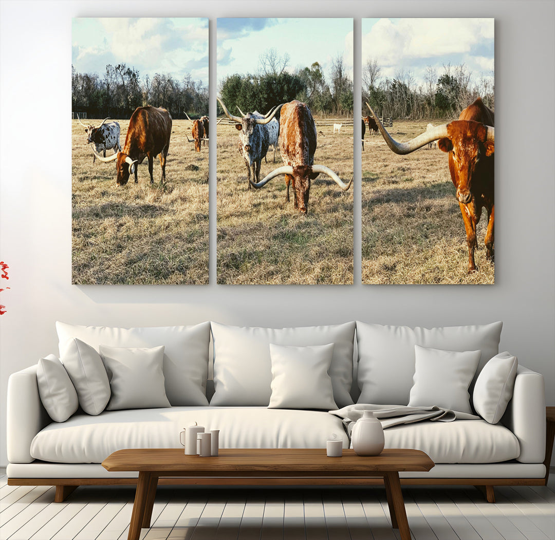 A herd of Texas Longhorn cattle grazing in an open field under a partly cloudy sky, capturing a rustic and Western ranch aesthetic.