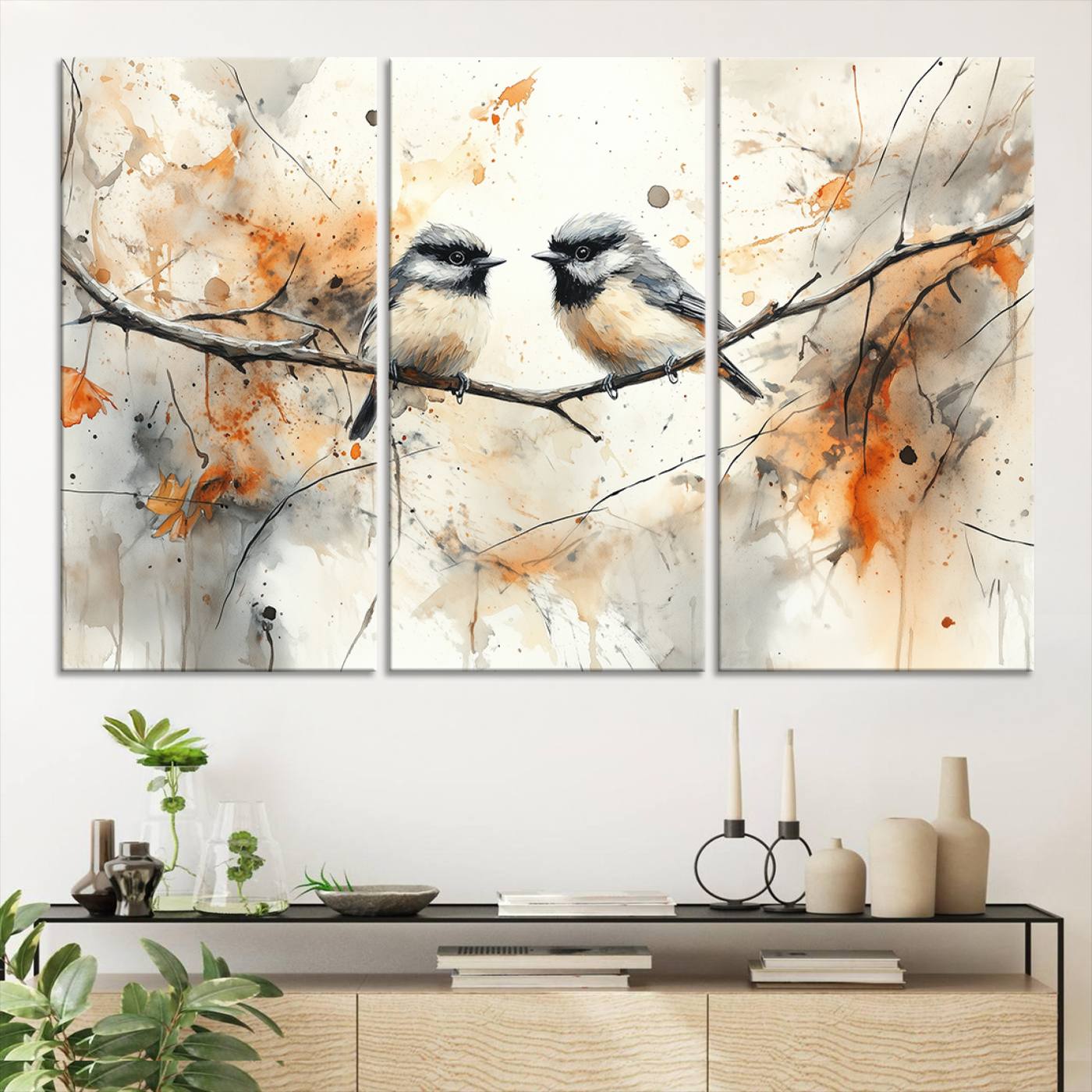 A soft and elegant watercolor painting of two chickadees perched on a delicate branch, surrounded by splashes of orange and neutral tones evoking a calm autumn day.