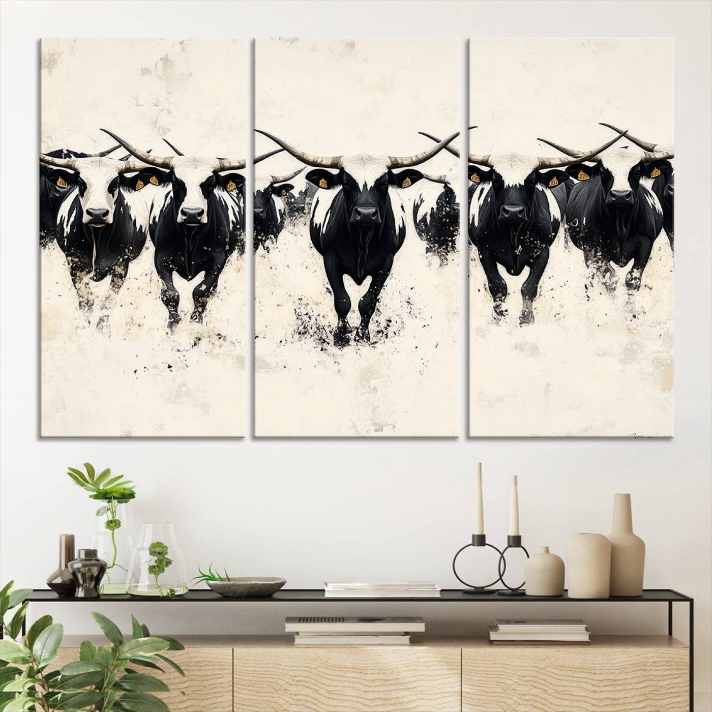 Canvas artwork of black and white Texas longhorns in a bold stampede over a minimalist background, ideal for rustic modern or Western-themed decor.