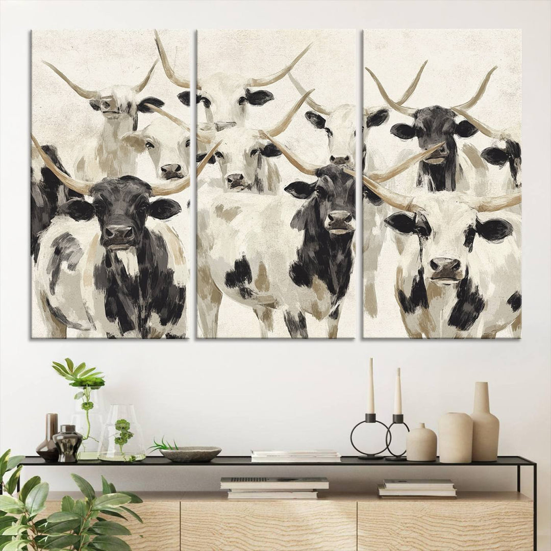 Canvas print titled Longhorn Texas Cow Drawing, depicting longhorn cattle with black and white markings, made in the USA, displayed on the wall.