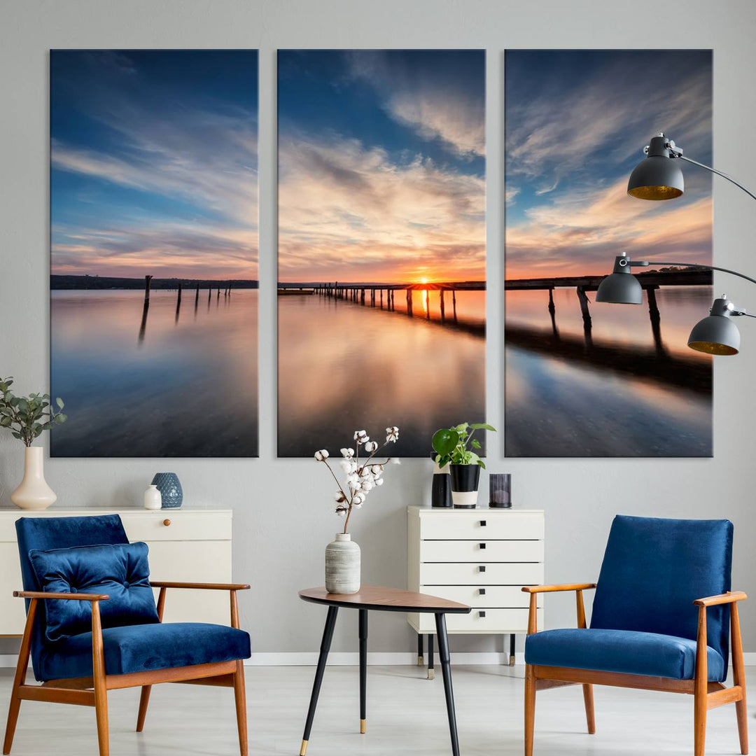 The Sunset Pier Canvas features a serene coastal landscape with vibrant hues under cloudy skies, ideal for modern decor.