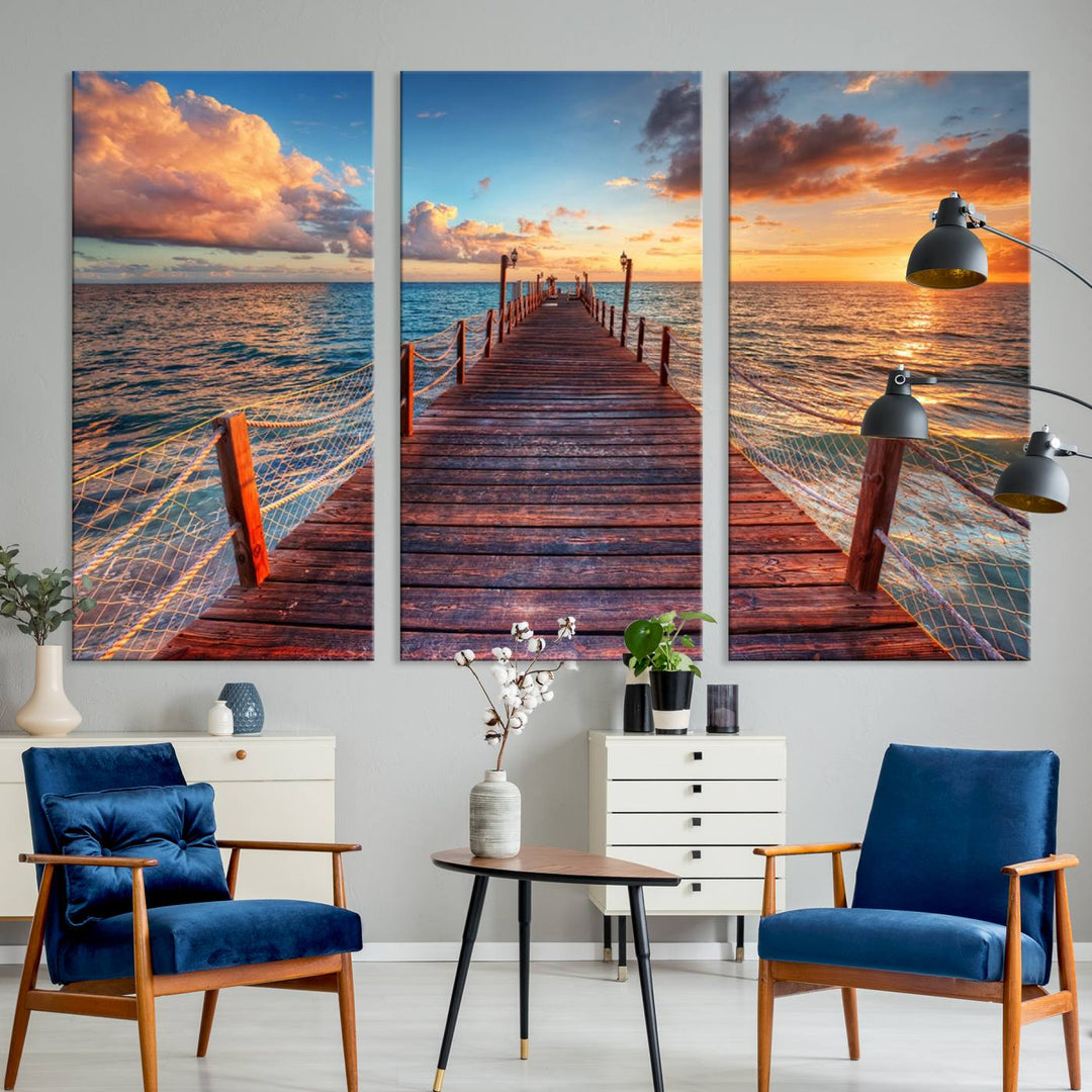 The Sunset Pier Canvas Wall Art is a triptych featuring an ocean landscape that elegantly captures a tranquil beach sunset with gentle ocean waves. It comes beautifully framed and ready to hang.