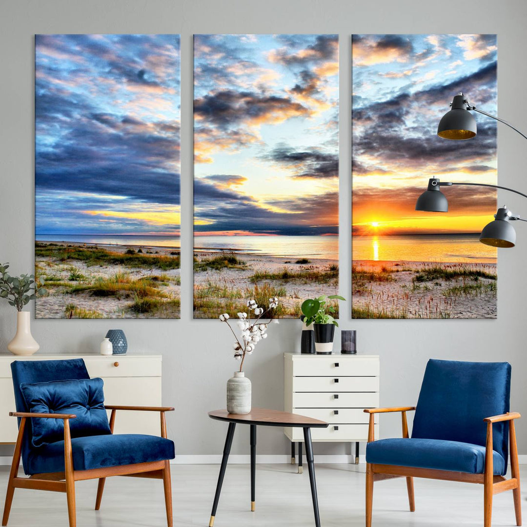 The Sunset On The Ocean canvas wall art features a beautiful beach sunset with grass and clouds.