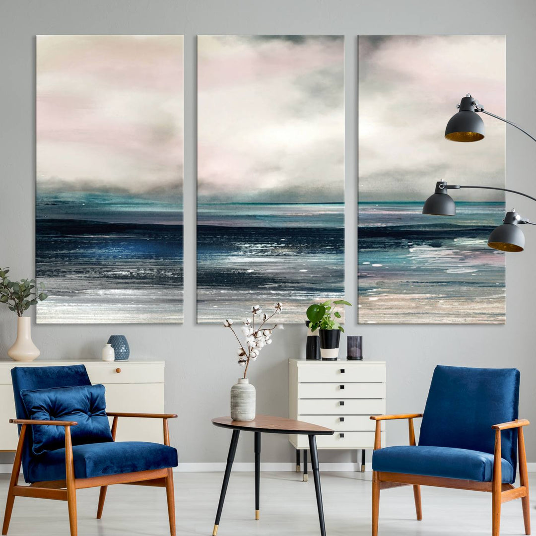 A contemporary abstract wall art canvas print in pastel pink, teal, and gray tones hangs on the wall.